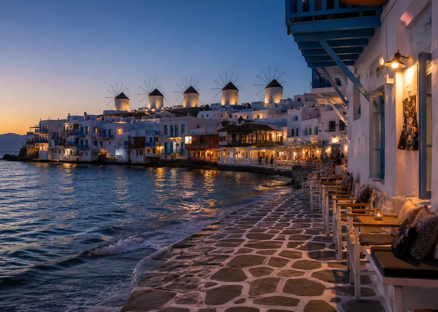 Seaside promenade at dusk with the windmills of Mykonos