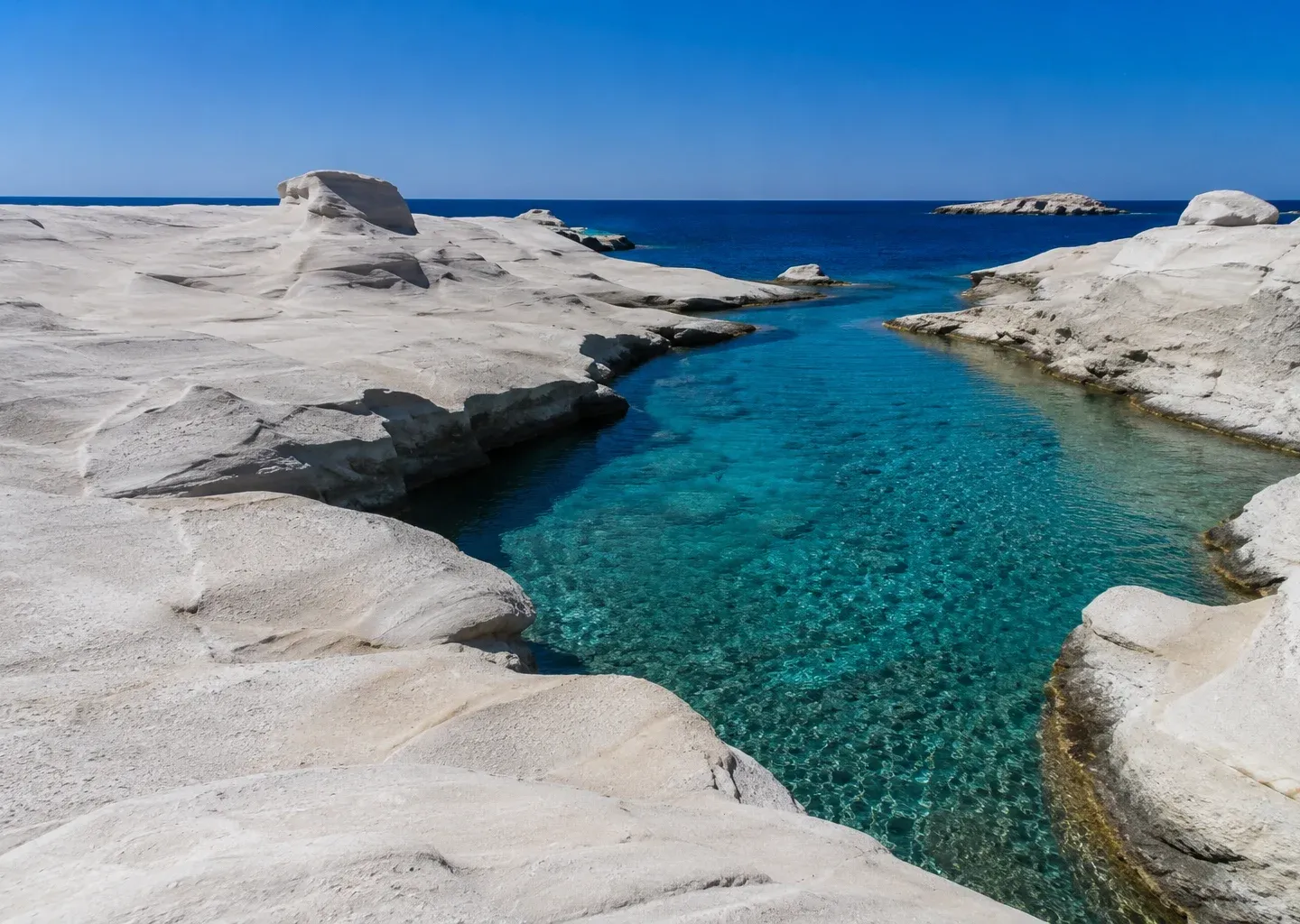 Coastal rock formations and a turquoise inlet in Crete